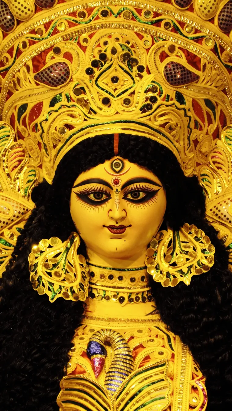 Ma Durga — the protima's face, crowned in gold daaker saaj